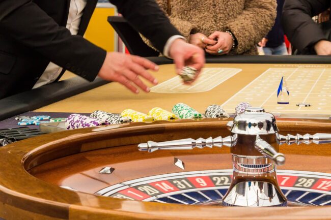 Game Selection. A dealer next to a roulette wheel